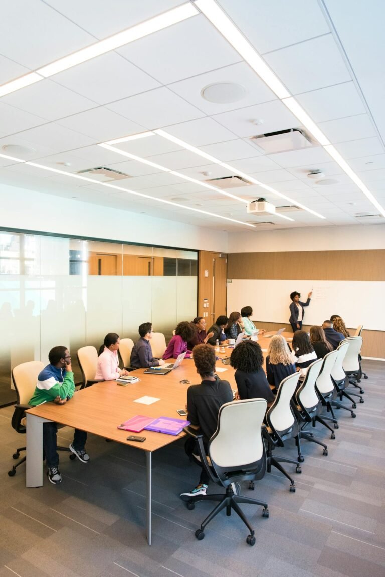 Professional team engaged in a collaborative boardroom meeting with a presentation in progress.